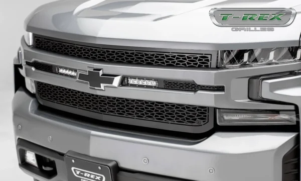 T-Rex LED lighted grille on Chevrolet Silverado pickup truck featuring black mesh design with integrated LED light bars available at Scorpion Truck Stuff in Edmonton, Canada.