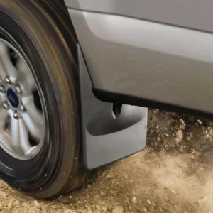 WeatherTech black front mud flaps installed on 2020 to 2025 models of Chevy Silverado Heavy duty truck, providing splash and debris protection on dirt road terrain, available at Scorpion Truck Stuff in Edmonton, Canada.