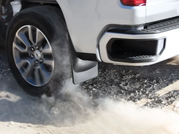 WeatherTech black rear mud flaps on 2021 to 2024 models of Ford F150 truck, demonstrating splash and debris protection during off-road driving, available at Scorpion Truck Stuff in Edmonton, Canada.