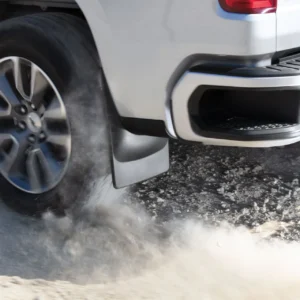 WeatherTech black rear mud flaps on 2020 to 2024 models of GMC Sierra Heavy duty truck, demonstrating splash and debris protection during off-road driving, available at Scorpion Truck Stuff in Edmonton, Canada.